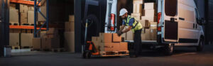 Worker loading a van with packages.