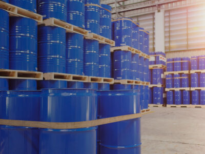 Steel drums used for hazardous materials safely stored in a warehouse.